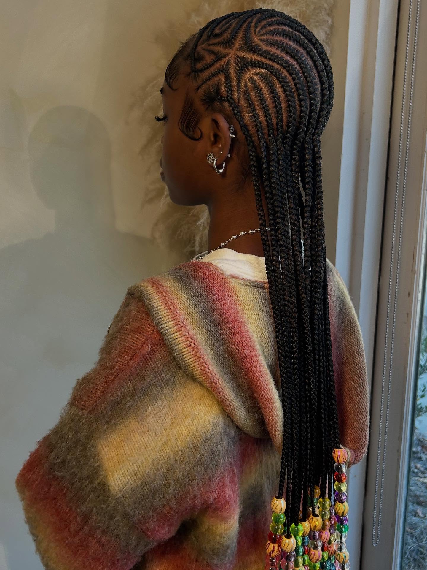 Black beaded cornrows with a star pattern