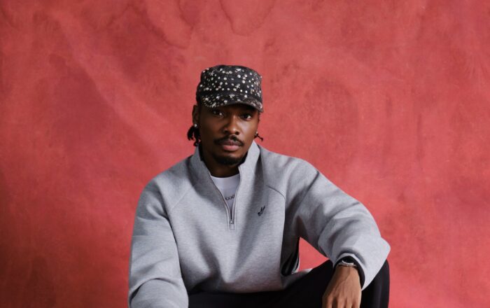Mike Afolarin in a grey Adidas sweatshirt