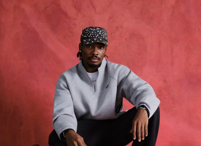 Mike Afolarin in a grey Adidas sweatshirt