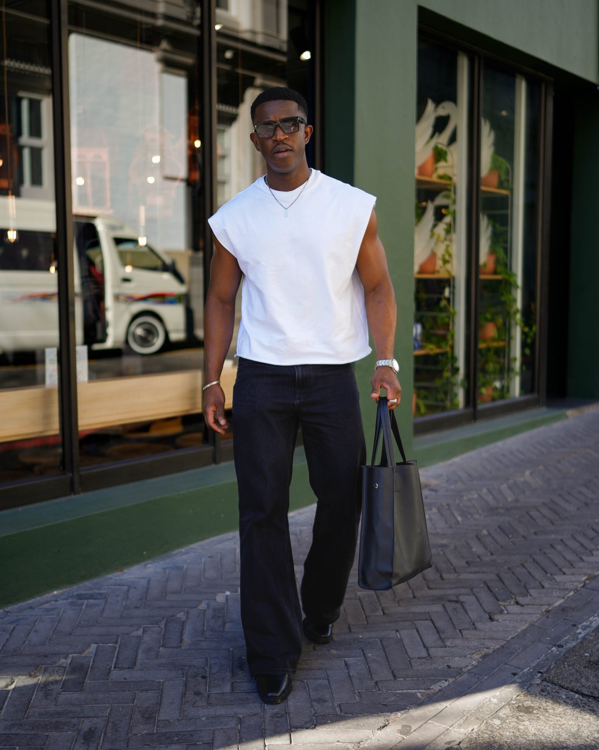 Sleeveless white shirt and bootcut jeans for men