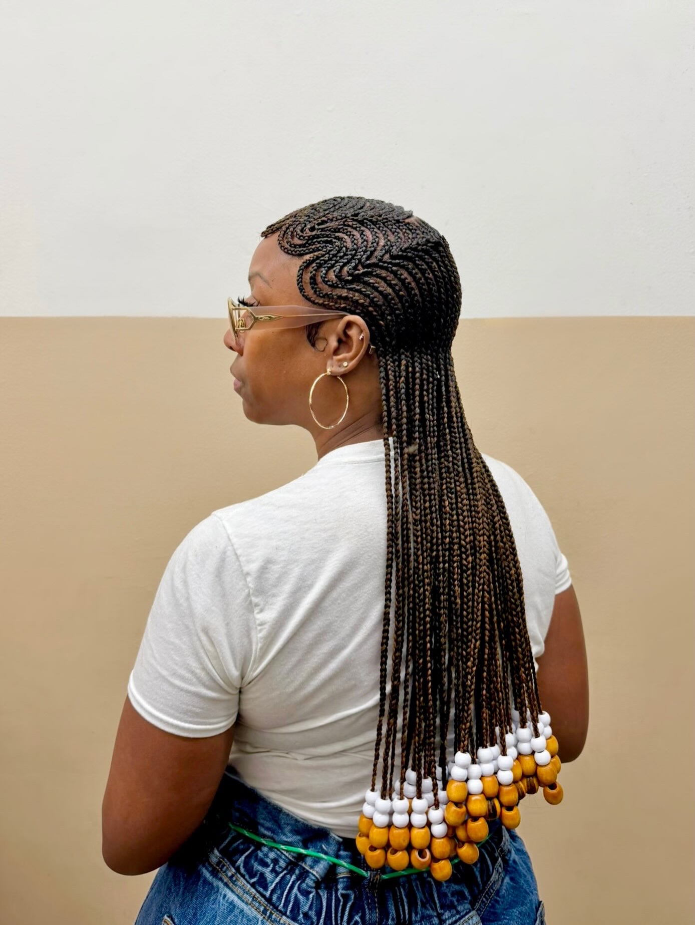 Long cornrow hairstyle with coloured beads